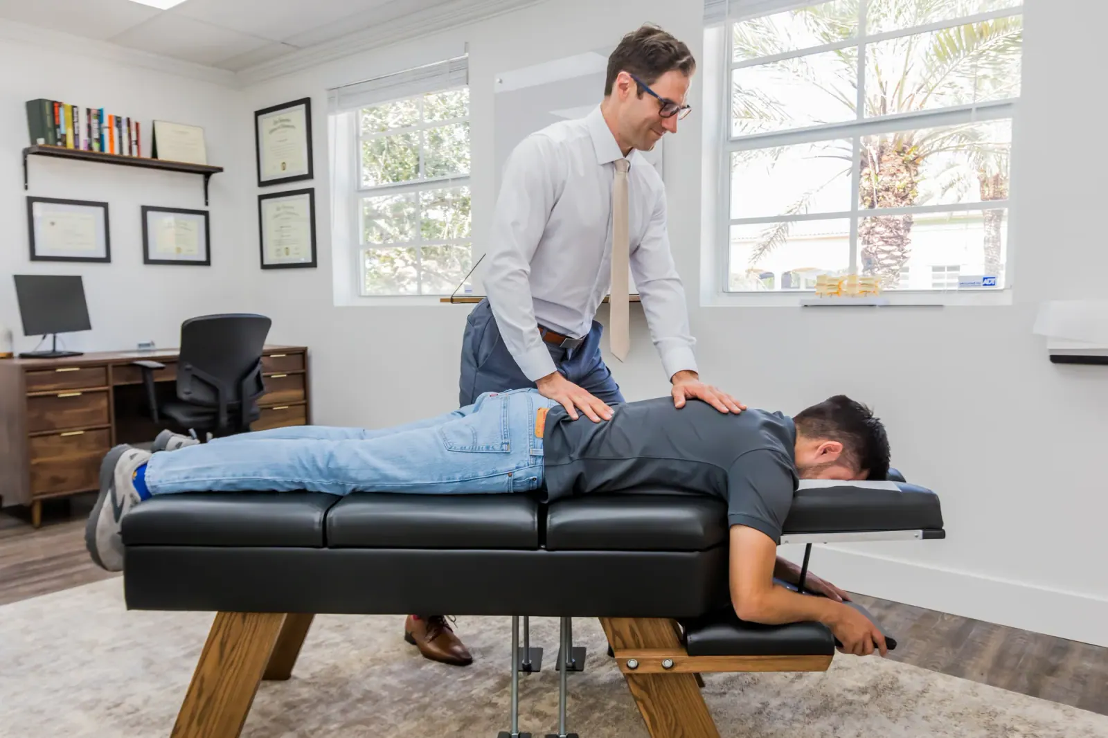 Chiropractor adjusting a patient's back in the Weston office