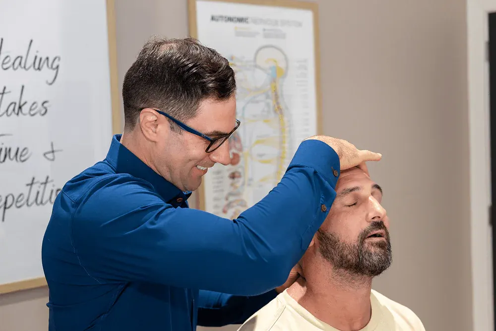 Dr. David Ridos performing a cervical adjustment