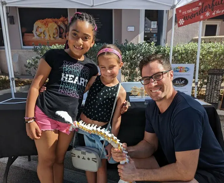 Dr. David Ridos with children at a community event