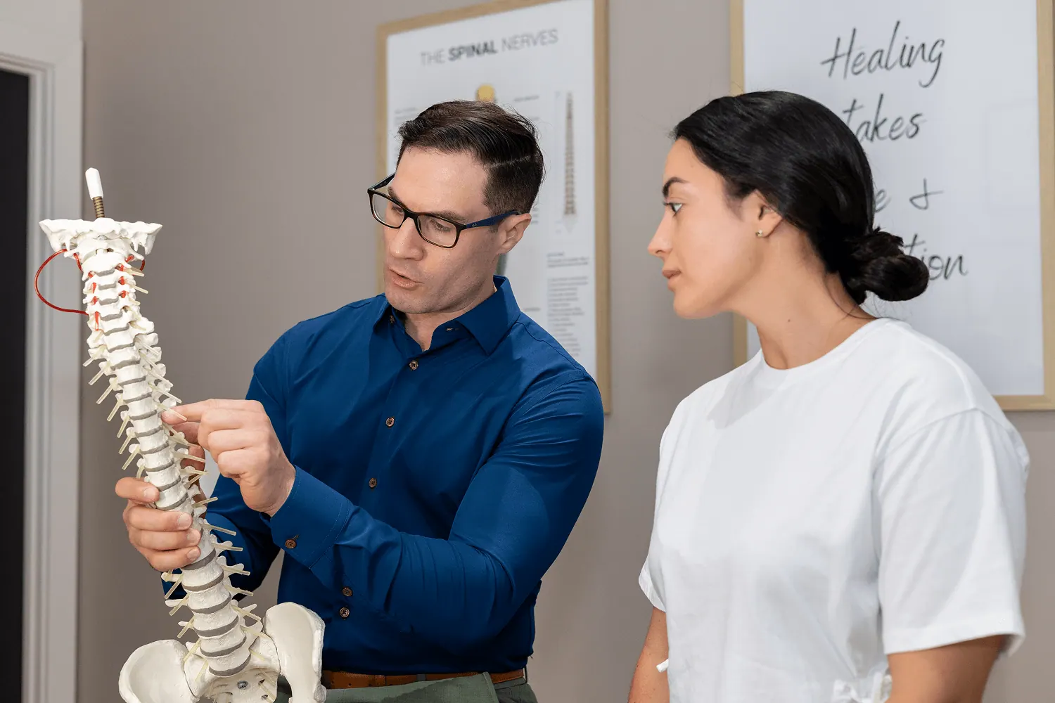 Dr. David Ridos explaining a spine model to a patient