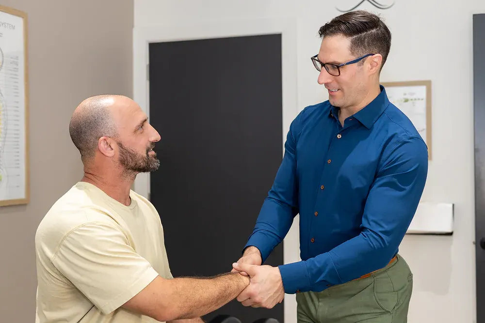 Dr. David Ridos shaking hands with a patient
