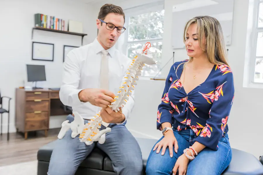 Dr. David Ridos explaining spine model to patient