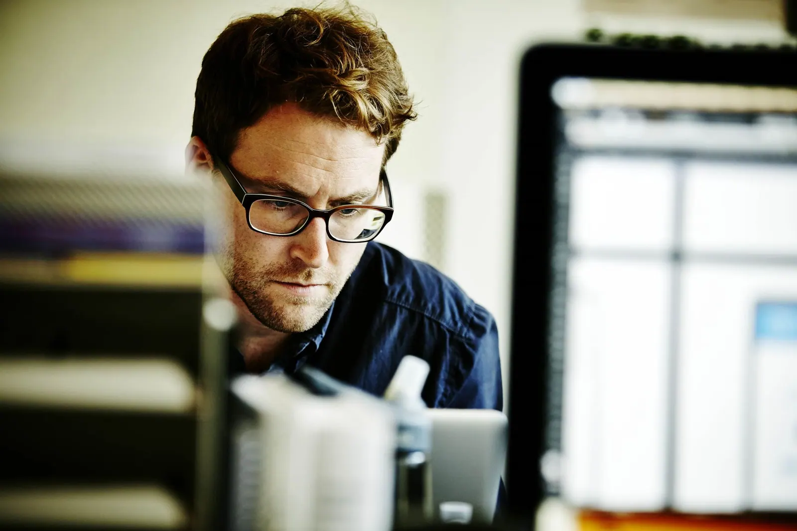 Man looking stressed at his computer
