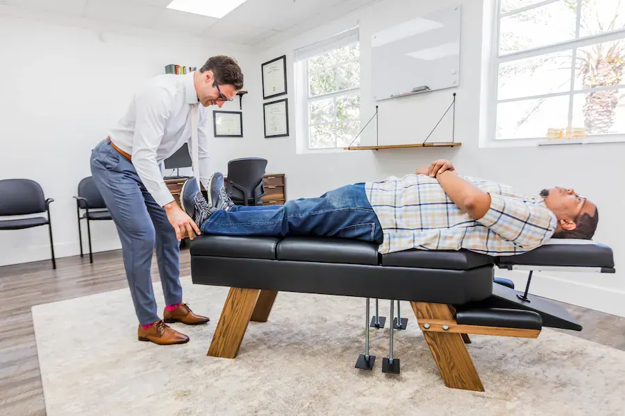 Dr. David Ridos treating patient on chiropractic table